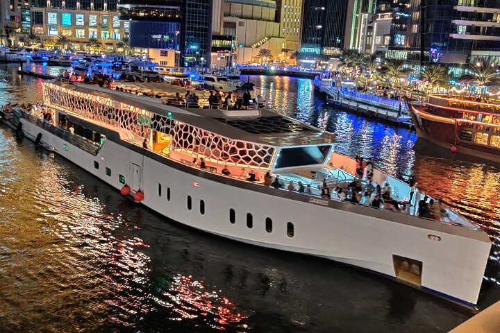 Experience Dubai's skyline from the largest yacht enjoying live cooking international cuisine and a DJ as you sail past iconic landmarks. An unforgettable evening awaits!